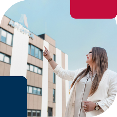 Ameripol-Rzeszowoffice-female-pointing-at-the-building